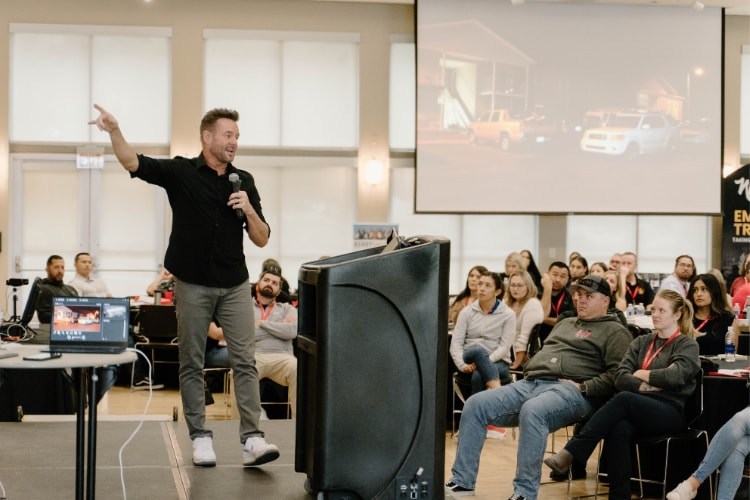 John Speaking at a Conference